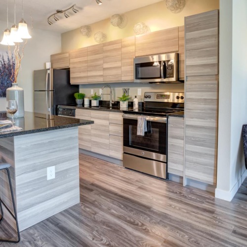 a kitchen with a bar and chairs